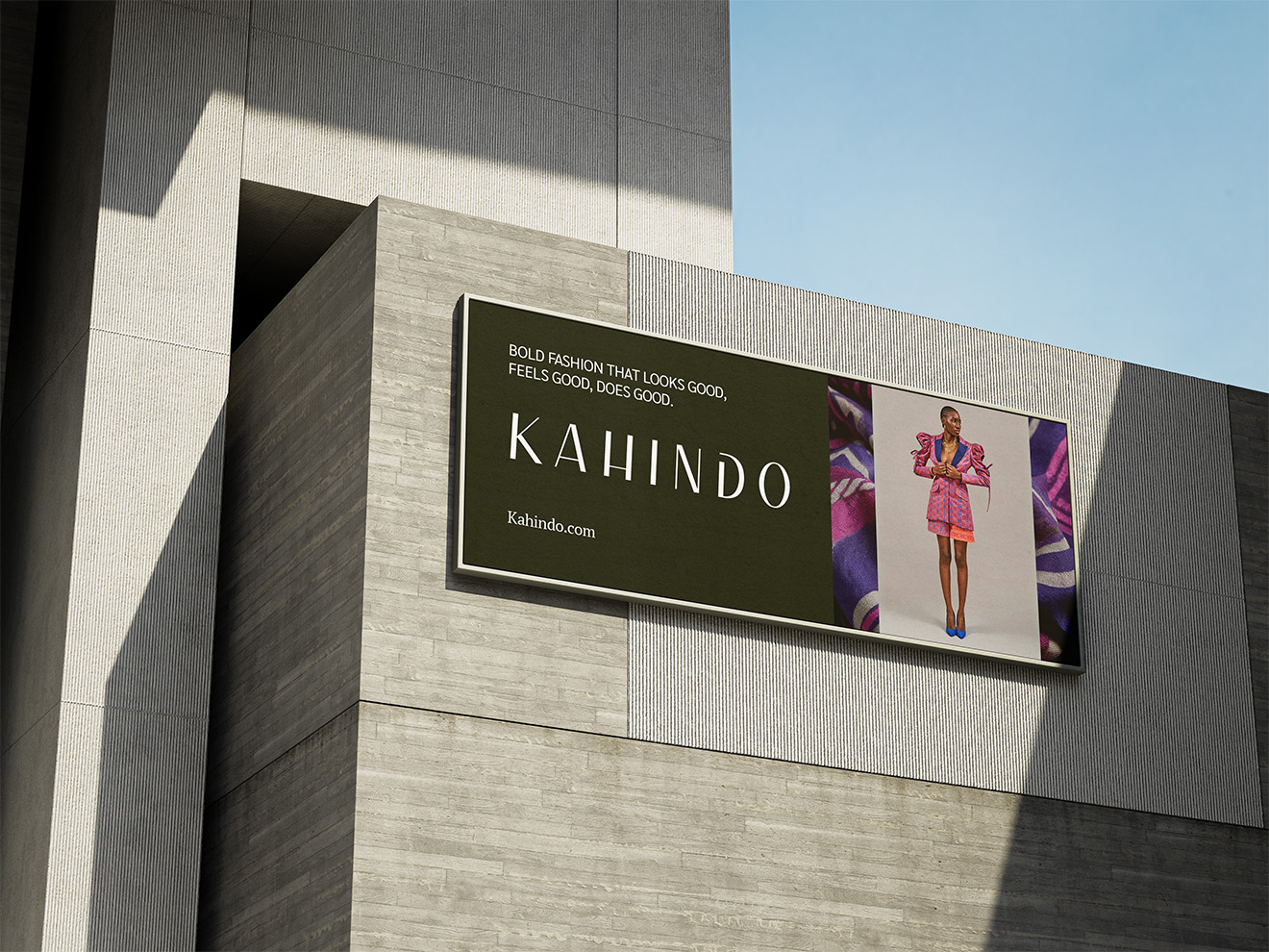 A mock up rendering of a billboard on the side of a stone building showing a fashion brand named "kahindo" in bold black and white lettering.