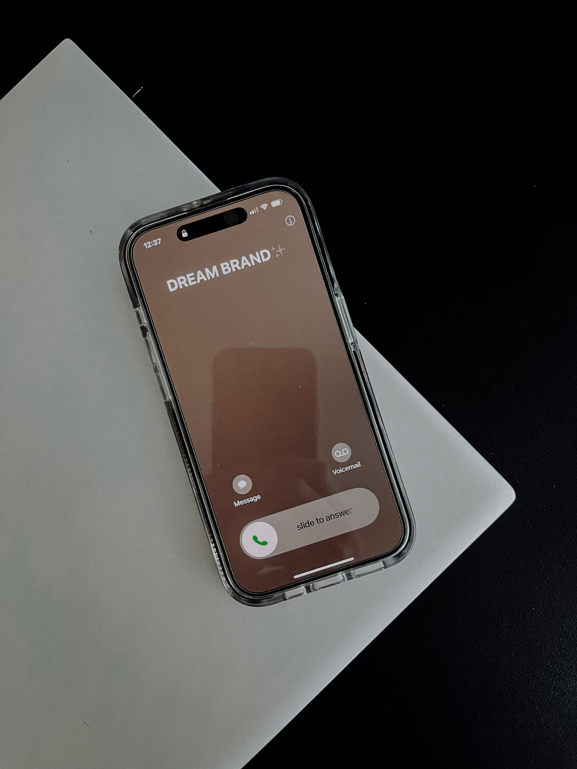 an iphone with an incoming call. caller id says "dream brand"